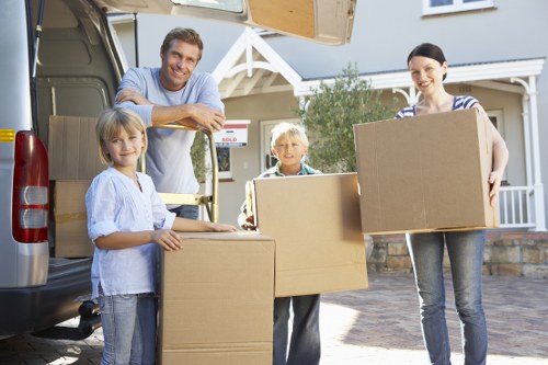 Moving boxes and furniture prepared for a house move in Harrow